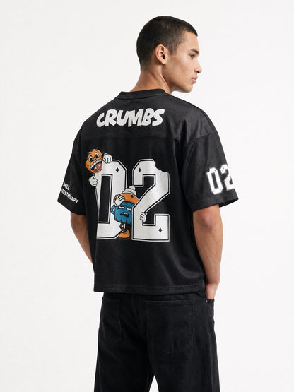 Two Crumbs mesh jersey tee in black — back view, CRUMBS yoke with 02 number and mascot graphic, drop-shoulder fit