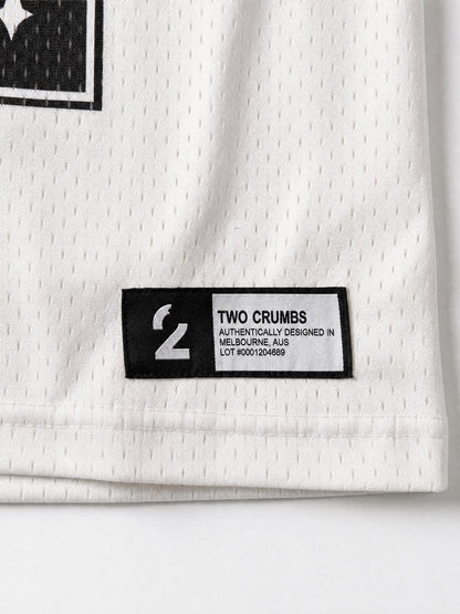 Two Crumbs mesh jersey tee in white — hem tag detail, woven label with brand and lot number